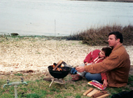Dave Fontana and son Aidan roasting marshmallows in Chincoteague, Virginia in April 2001